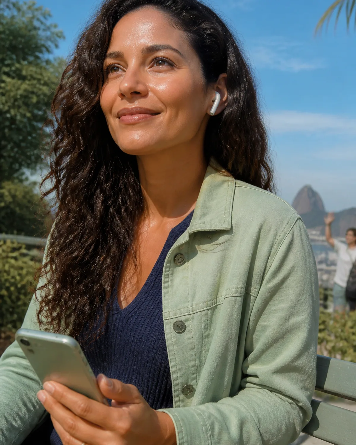 A learner on a balcony talking on a phone, looking up, not scrolling